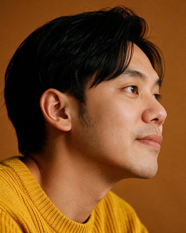 Portrait of Yudo Mochdie in profile, mustard sweater